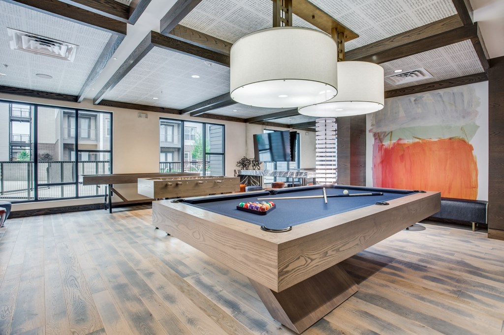 clubhouse with pool table and ping pong table in the middle