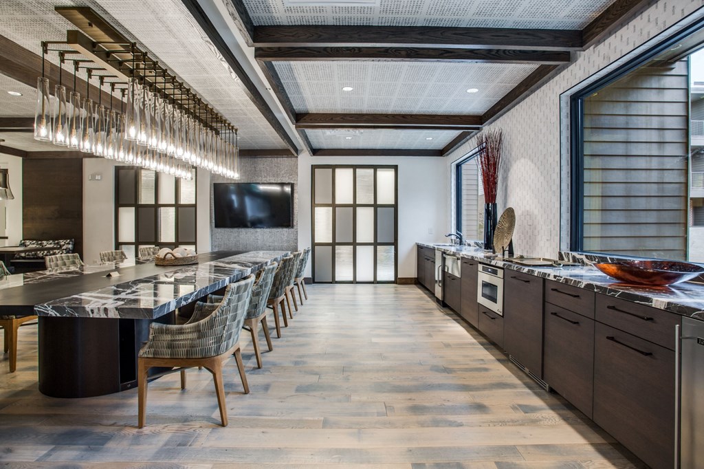 a large kitchen and dining room with a long table and chairs