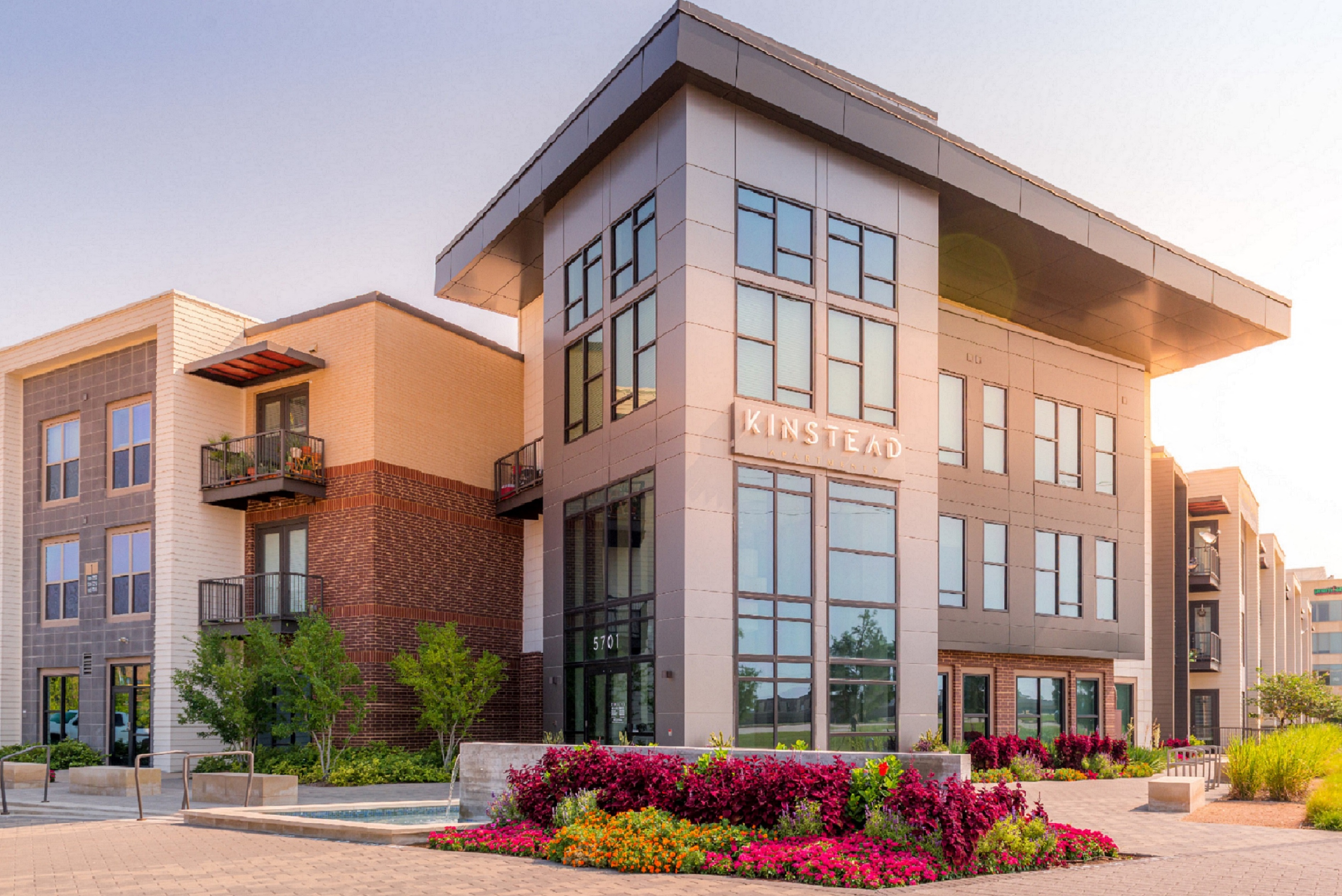 a rendering of a building with flowers in front of it