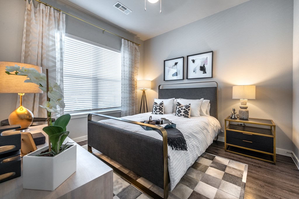 a bedroom with a bed and a dresser and a window