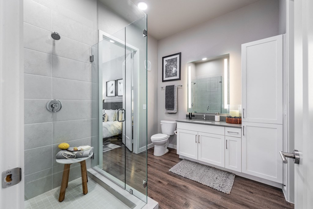 a bathroom with a shower and a sink and a toilet