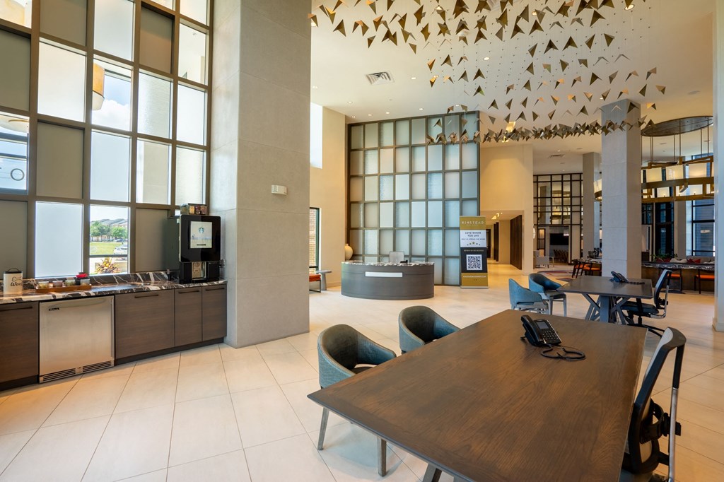the lobby of a hotel with a table and chairs