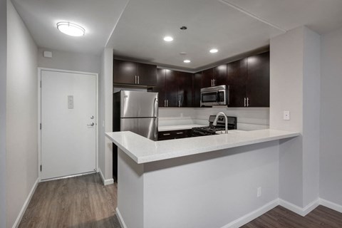 a kitchen with a counter top and a refrigerator
