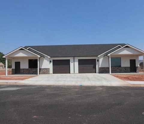 a house with two garage doors and a driveway