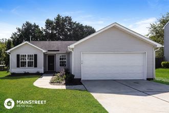 a white house with a white garage door and a driveway