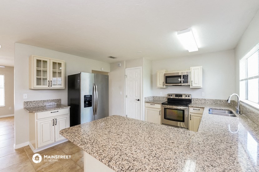 a kitchen with granite counter tops and stainless steel appliances