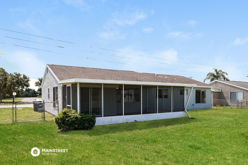 the front of the house with a lawn and a porch