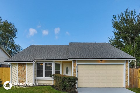 the front of a house with a garage door