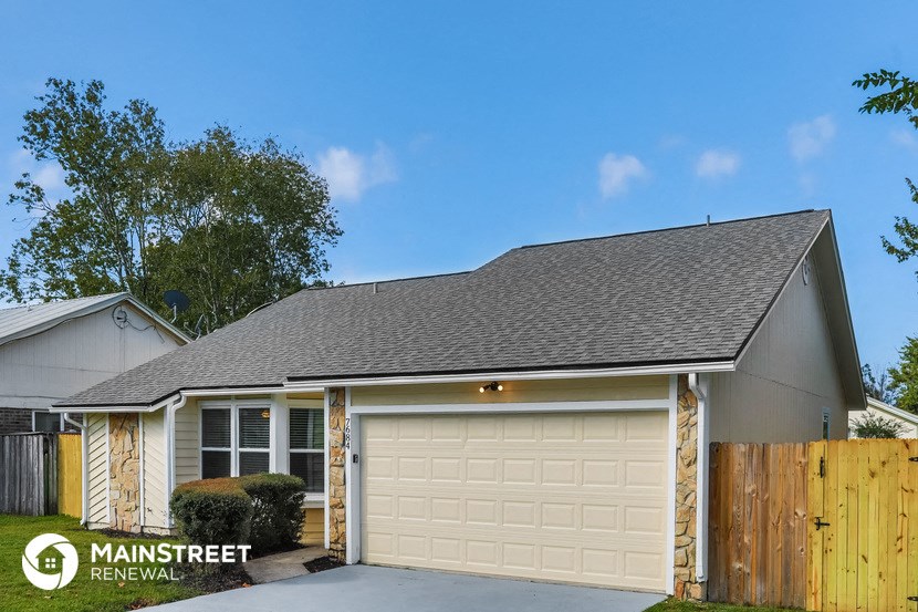 the front exterior of a home with a white garage door