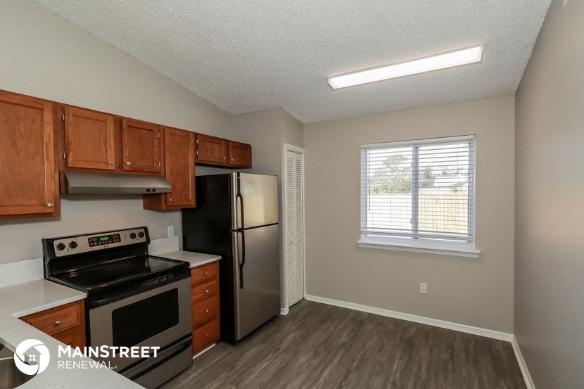 the kitchen of our studio apartment atrium with stainless steel appliances and wooden cabinets