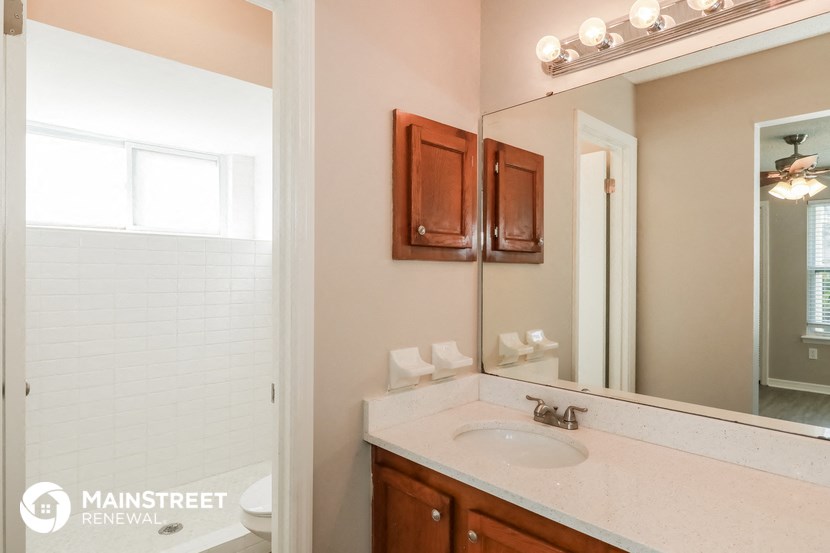 a bathroom with a sink and a mirror and a toilet