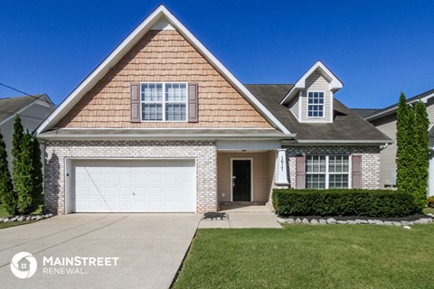 a house with a white garage door and a lawn