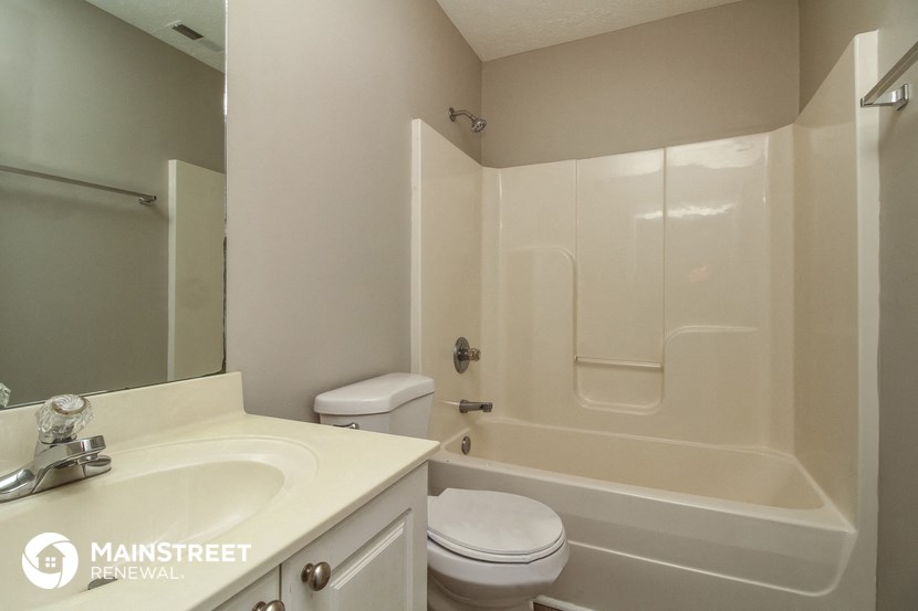 a bathroom with a sink toilet and a bath tub