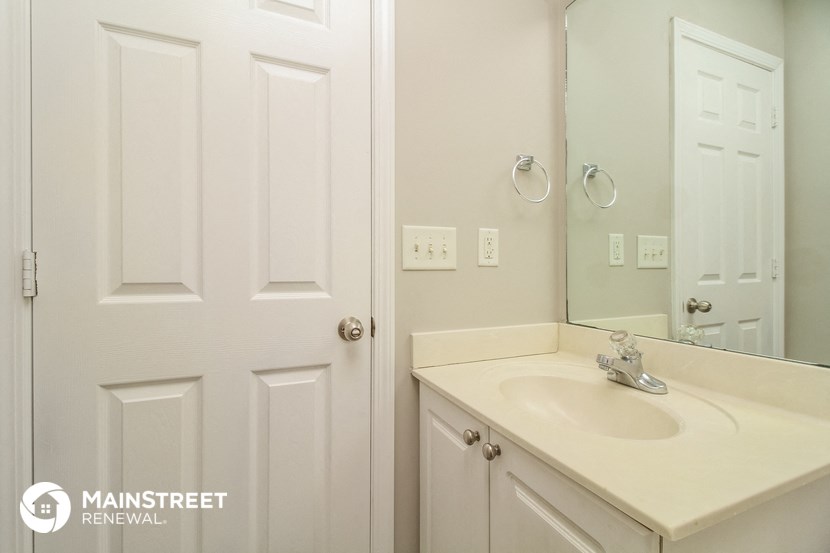 a small bathroom with a sink and a mirror