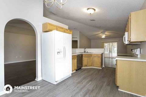 a kitchen with wooden cabinets and a white refrigerator