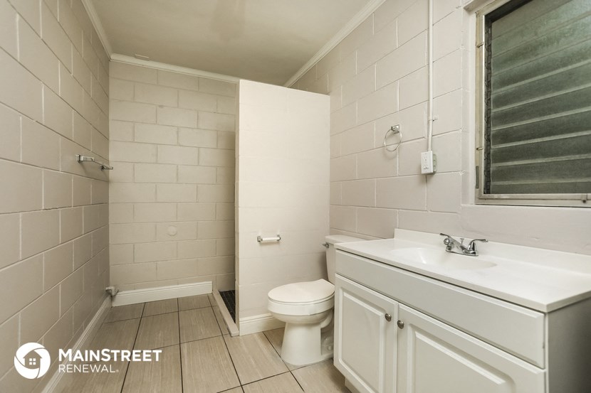 a white bathroom with a toilet and a sink