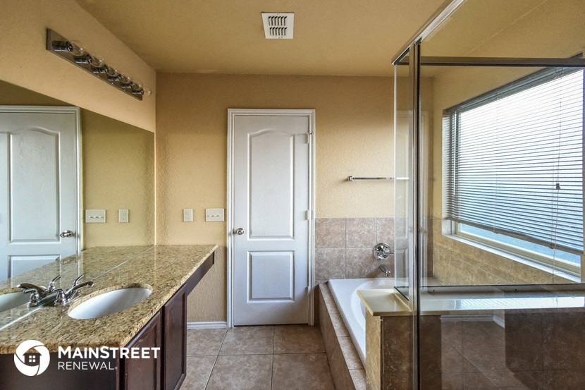 a bathroom with a shower and a sink and a bath tub