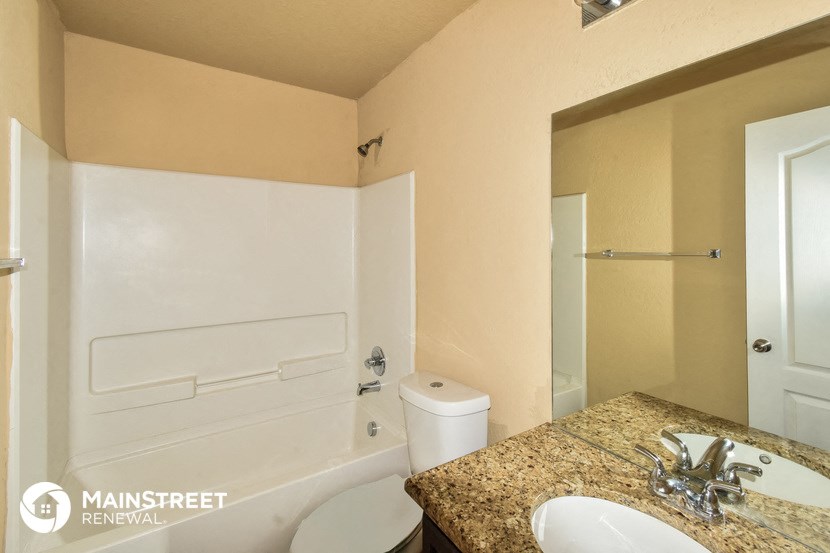 a bathroom with a sink and a toilet and a tub