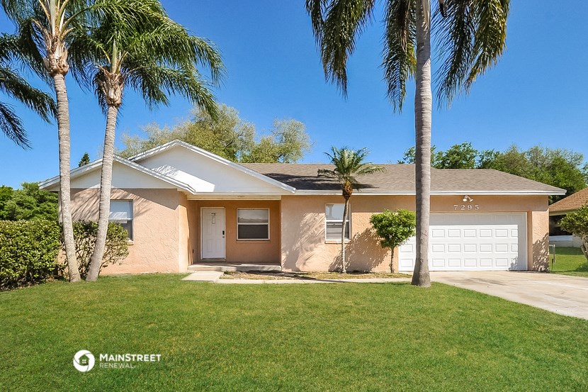a pink house with palm trees in front of it