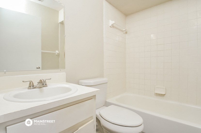 a bathroom with a sink toilet and a bath tub