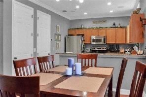 a kitchen with a wooden table and chairs