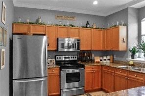 a kitchen with stainless steel appliances and wooden cabinets