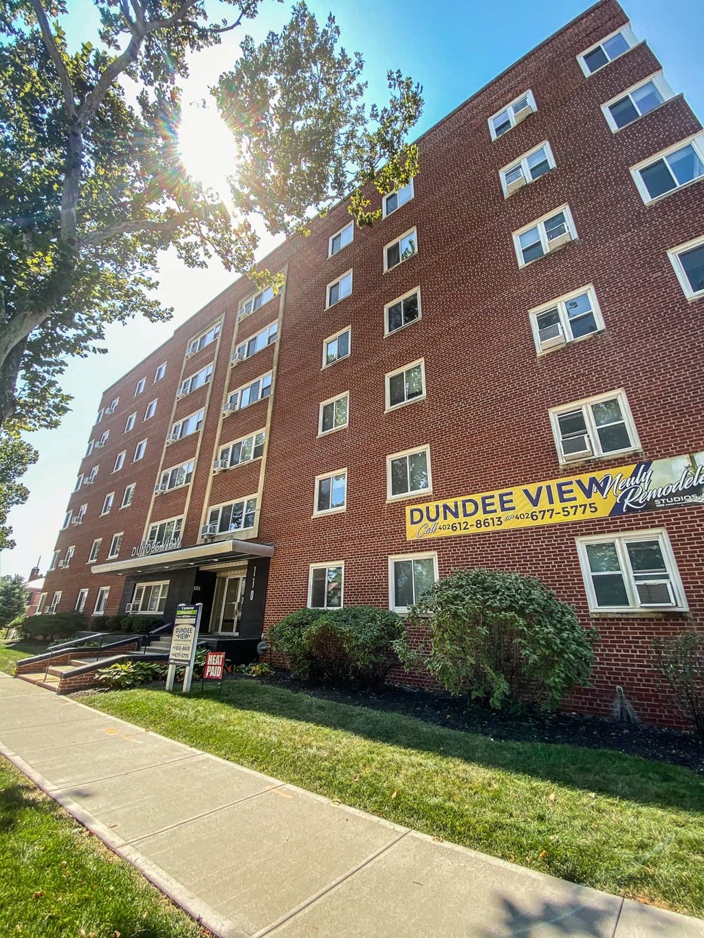 a brick building with a yellow sign in front of it