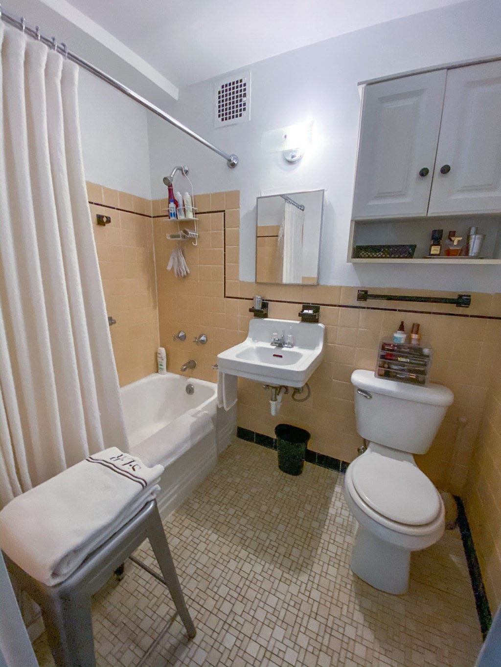 a bathroom with a toilet sink and bath tub and a shower curtain