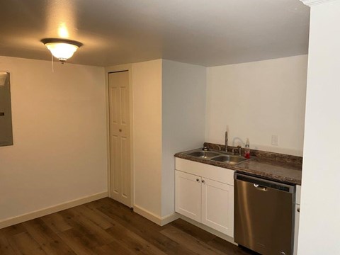 A small kitchen with a sink and a dishwasher.