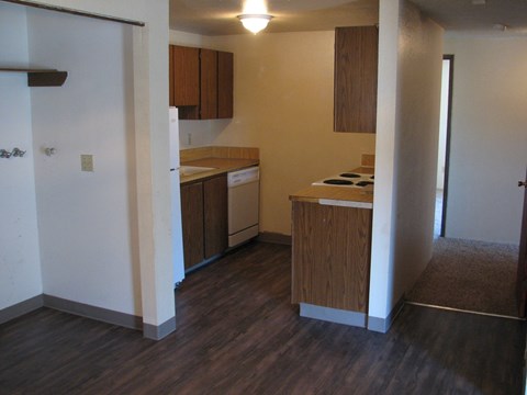 A kitchen with wooden cabinets and a white refrigerator.