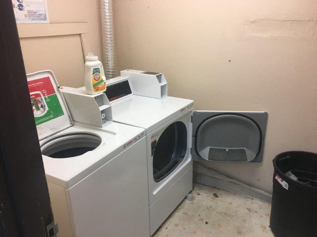 A washing machine and dryer are in a small room.