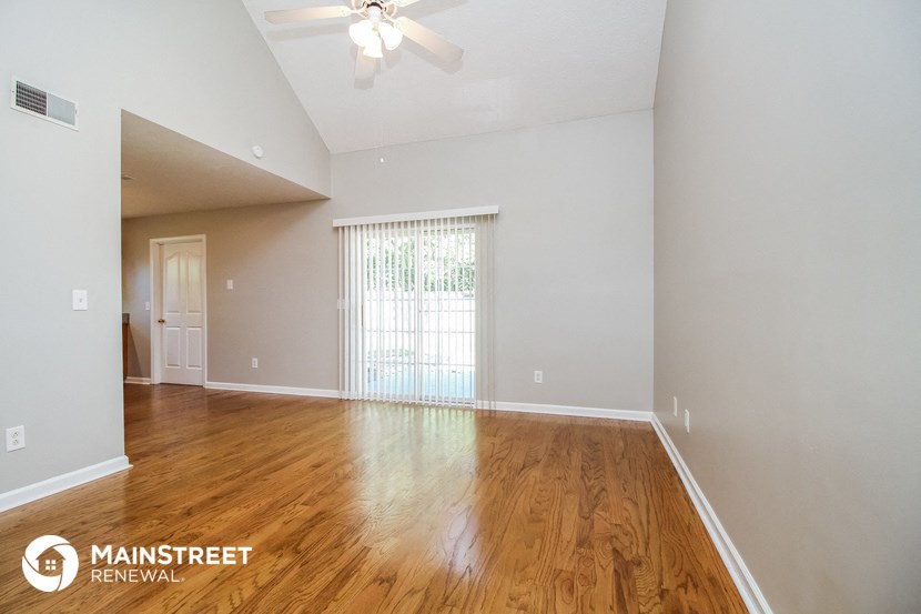 the living room and dining room with wood flooring