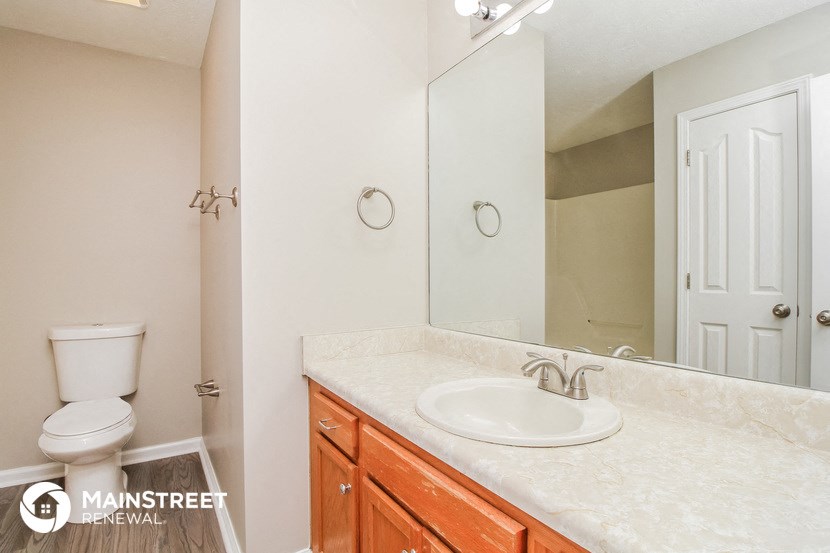 a bathroom with a sink and a mirror and a toilet