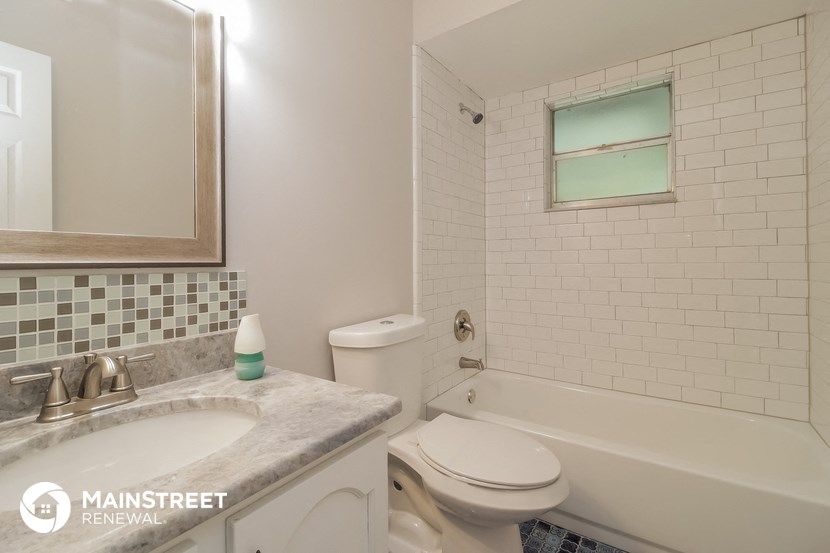 a bathroom with a sink toilet and a bath tub