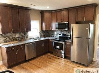A kitchen with wooden cabinets and stainless steel appliances.