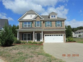 a large brick house with a white garage door