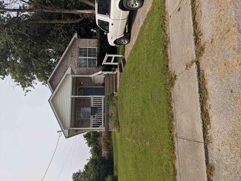 an aerial view of a house with a truck parked in front of it