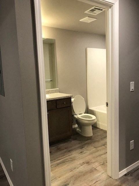 a bathroom with a toilet and a sink and a mirror