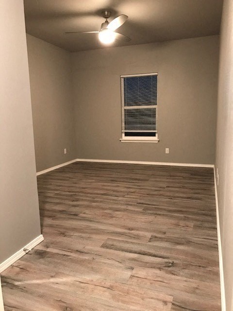 a empty room with wood floors and a window