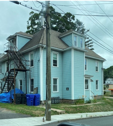 a blue house on the corner of a street