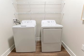 Separate laundry room with full-size washer and dryer