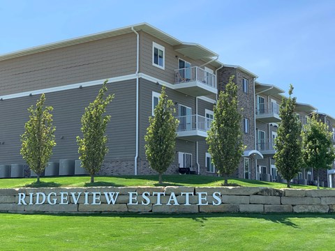 a large apartment building with a sign in front of it