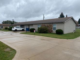 a house with a white car parked in front of it