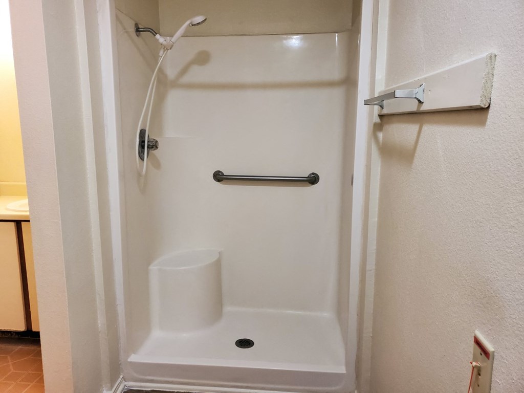 a shower in a bathroom in a hotel room