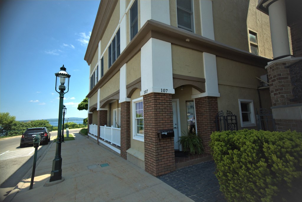 A building with a mailbox on the front porch.