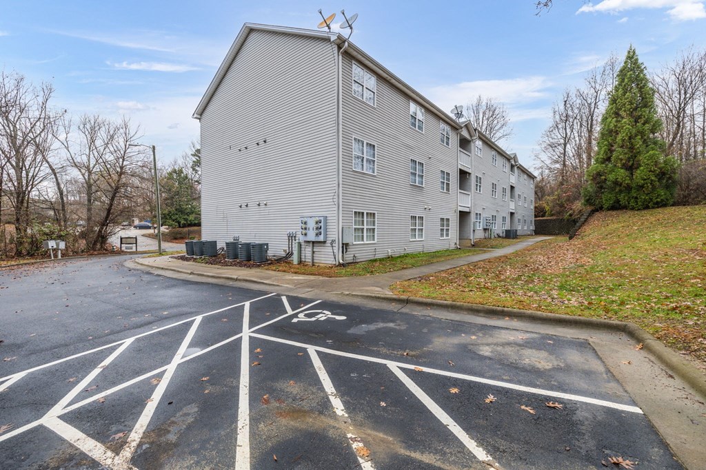 an empty parking lot in front of an apartment building