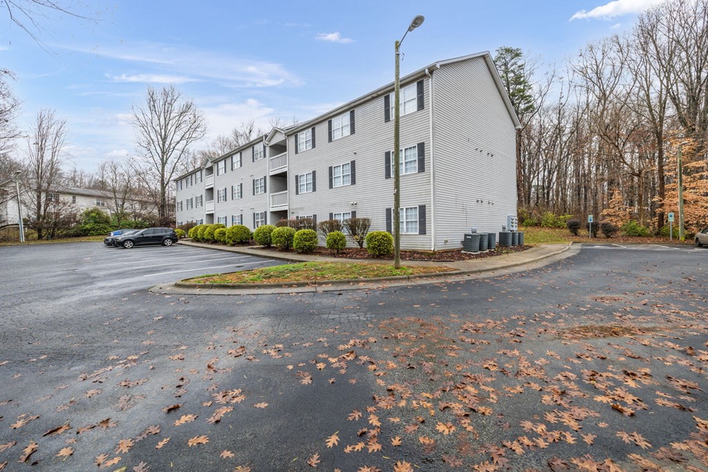 a white apartment building with a roundabout in front of it