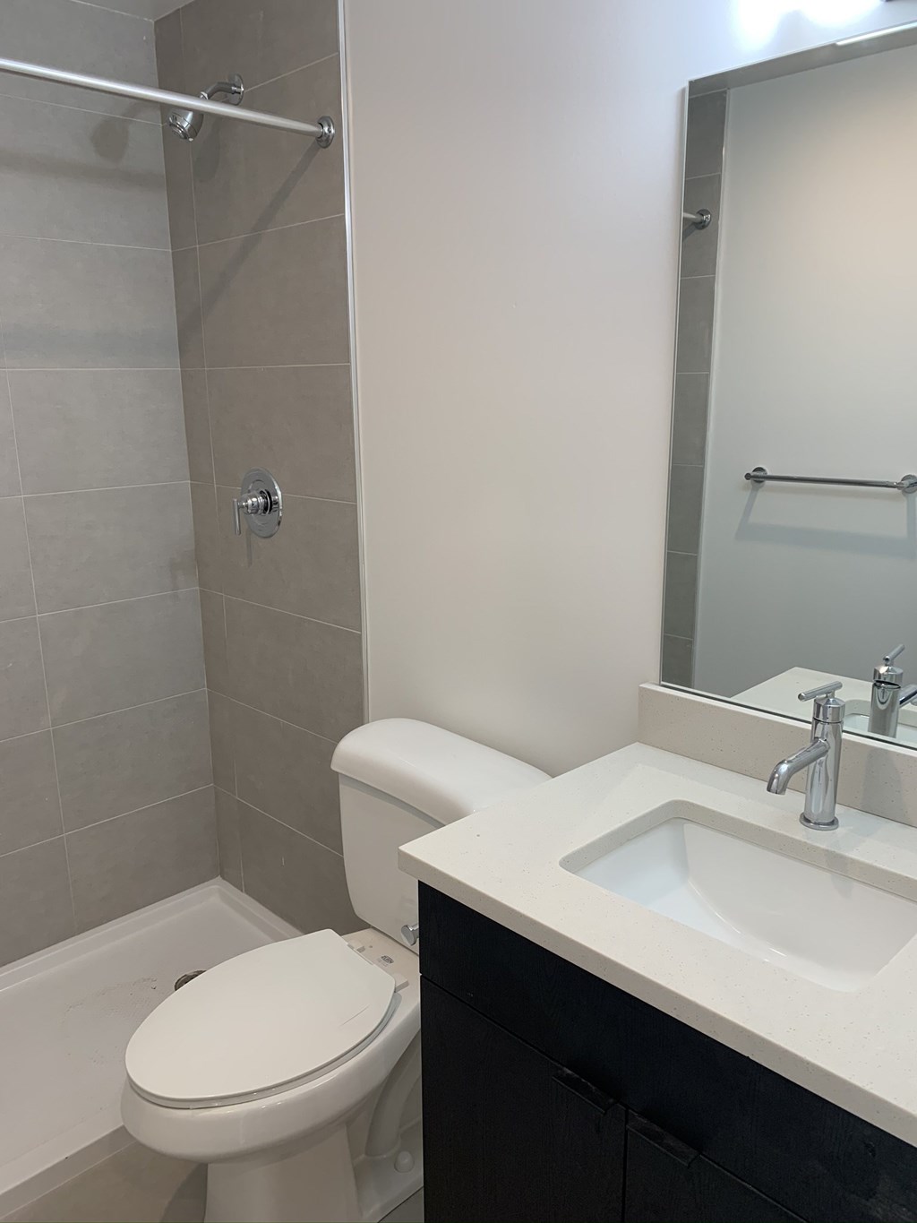 a small bathroom with a sink toilet and shower