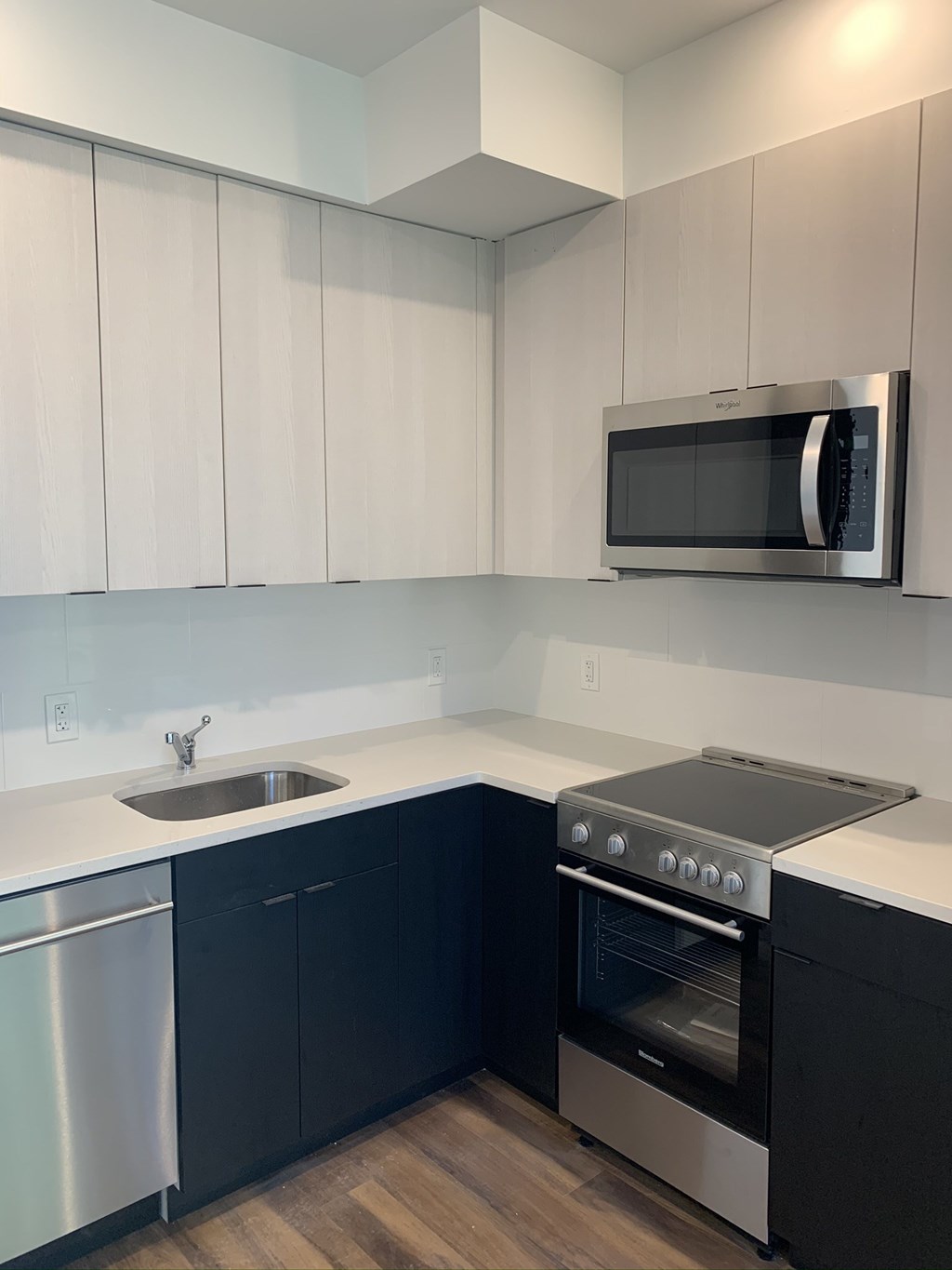 a kitchen with a sink and a stove and a microwave