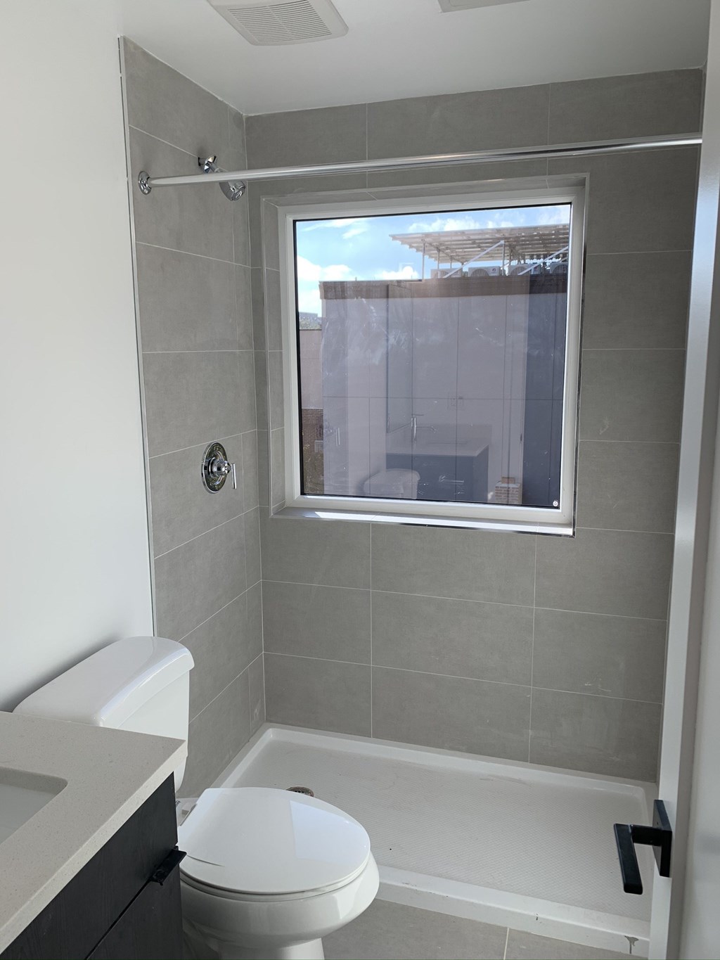 a small bathroom with a toilet and a window